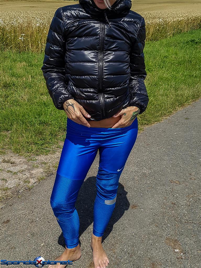 Black downjacket and shiny blue Nike leggings